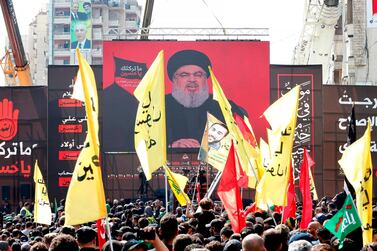 Supporters of Hezbollah in Lebanon gather near a giant poster of their leader Hassan Nasrallah. AFP