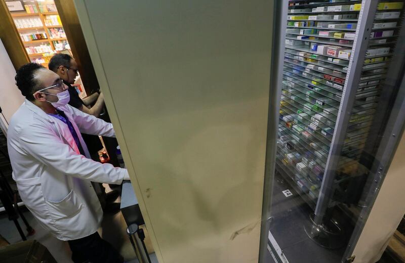 Dr Wael Abd Elaziz wearing a protective mask places his order at Dawa Pharmacy, the first Egyptian pharmacy using a robotic device that handles prescriptions, in Cairo, Egypt. Reuters