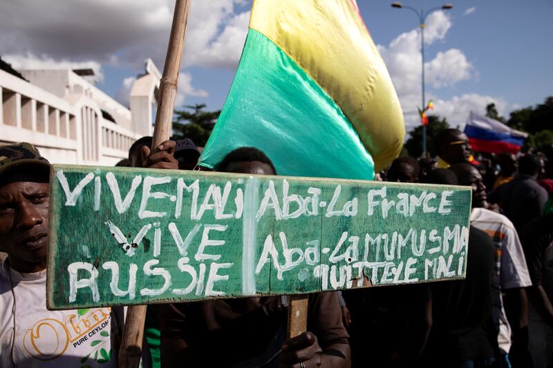 A demonstrator holds a sign reading, 'Long live Mali, long live Russia, down with France, down with Minusma' in Bamako. EPA