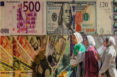 A poster depicting US  dollars and other foreign currencies outside an exchange office in Cairo, Egypt. AP