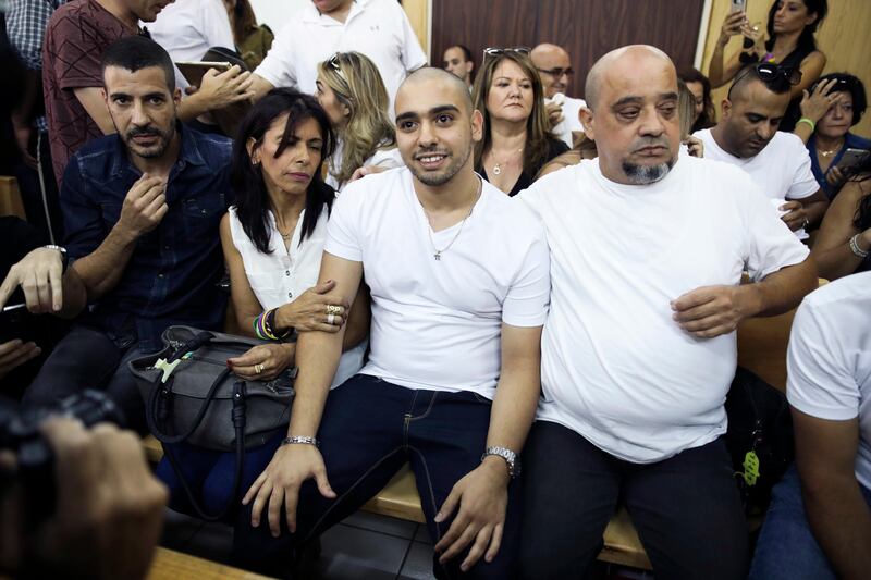 Elor Azaria, flanked by his parents, sits in an Israeli military court in Tel Aviv on July 30, 2017 as he waits to hear the verdict on an appeal against his conviction and 18-month sentence for manslaughter. Dan Balilty / AP Photo