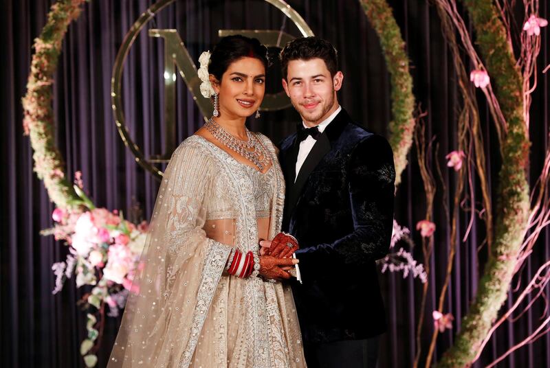 Newlyweds Priyanka Chopra, 36, and Nick Jonas, 26, pose for a photograph during a reception at a hotel in New Delhi on December 4, 2018. Photo: Reuters