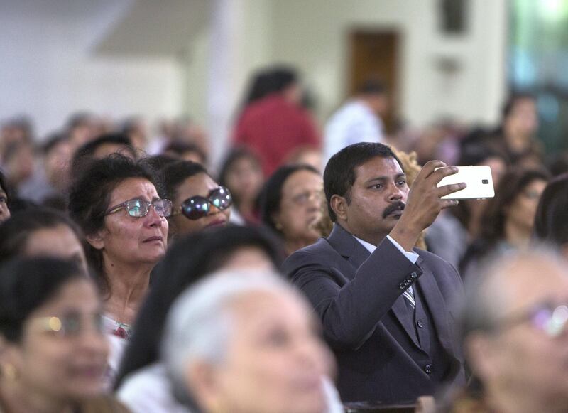 DUBAI, UNITED ARAB EMIRATES - Worshippers are emotional upon seeing the Pope on the screen at St. Mary's Church, Oud Mehta.  Leslie Pableo for The National for Nick Webster's story