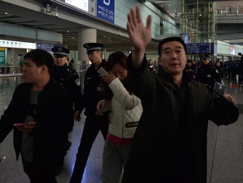 A possible relative cries at the Beijing Airport after news of the missing Malaysia Airlines Boeing 777-200. AFP 