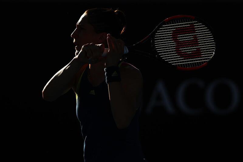 Andrea Petkovic plays a backhand in her first round match against Petra Kvitova. Cameron Spencer / Getty Images