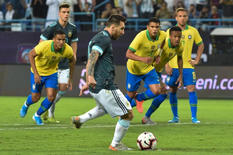 Argentina's forward Lionel Messi runs up to take a penalty during the match between Brazil and Argentina. He missed the spot kick but scored from the rebound. AFP