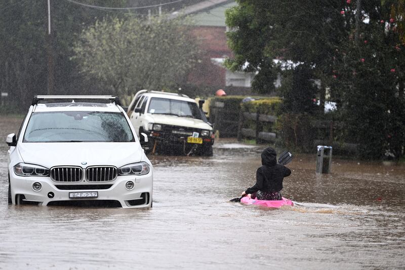 A child kayaks in floodwaters in the town of Yarramalong, north of Sydney, Australia. EPA