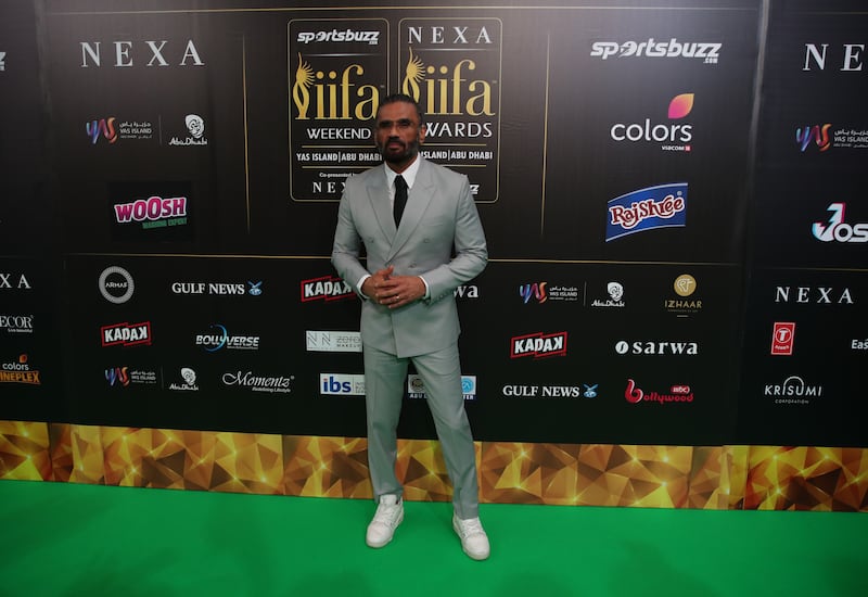 Suniel Shetty pairs his grey suit with trainers. EPA 
