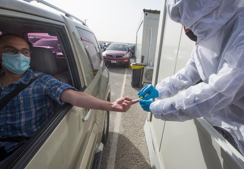 Dubai, United Arab Emirates - A passenger inside the car being tested by pricking blood sample before entering the Abu Dhabi at the new DPI Testing Centres border of Dubai and Abu Dhabi.  Leslie Pableo for The National for Shireena Al Nowais story