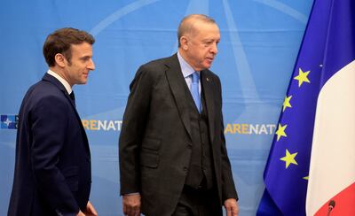 French President Emmanuel Macron, left, favours inviting Turkish President Recep Tayyip Erdogan to the summit. AP 