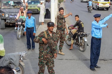 Yemeni policemen (in blue) and Houthi fighters control the traffic at the centre of the port city of Hodeidah on May 13, 2019. AFP