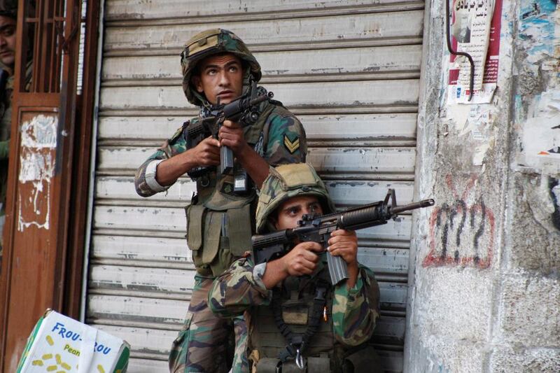 Lebanese army soldiers carry their weapons during clashes with militants in Tripoli on October 25, 2014. Reuters