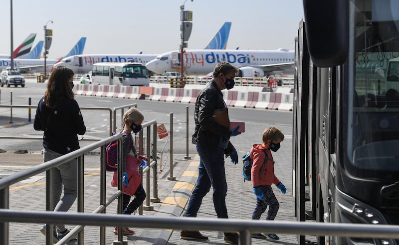 Passengers bound for Frankfurt board a shuttle bus at Dubai International Airport.