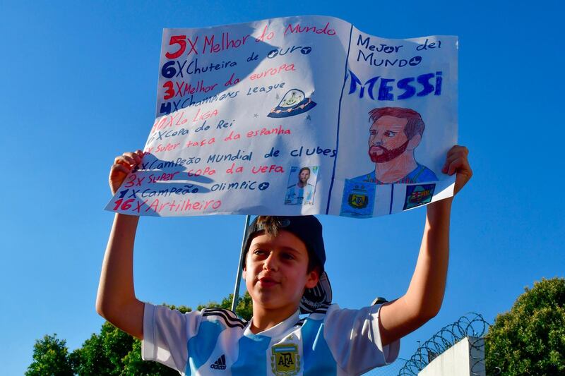 An Argentina fan holds up a sign with An image depicting Argentina's Lionel Messi to welcome Argentina's team before a training session in Belo Horizonte, Brazil. AFP