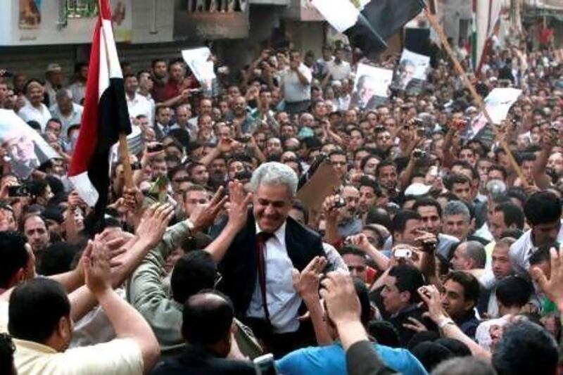 The Egyptian presidential candidate, Hamdeen Sabahi, greets his supporters during a campaign rally in the Nile Delta city of Al Manzala, some 160 kilometres north of Cairo on Saturday. Mr Sabahi heads the Karama party, an offshoot of the Nasserist party.