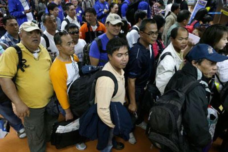 Filipinos who were working at the sprawling oil field in Algeria which was attacked by terrorists arrive at the Ninoy Aquino International Airport in Manila on Sunday. On Monday, the government said six of its citizens had died in the hostage crisis at the gas plant. Bullit Marquez / AP Photo