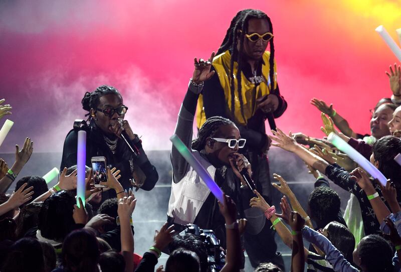 Offset, from left, Quavo and Takeoff, of Migos, perform. AP