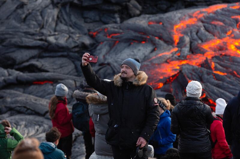 A man takes a selfie in front of the lava field  on the Reykjanes Peninsula. Getty Images
