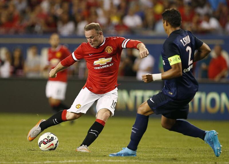 Manchester United and Wayne Rooney, left, face plenty of adversity ahead. With Robin van Persie and Radamel Falcao having left and Javier Hernandez out of favour, it leaves Rooney shouldering a heavy burden up front. JOSHUA LOTT / AFP

