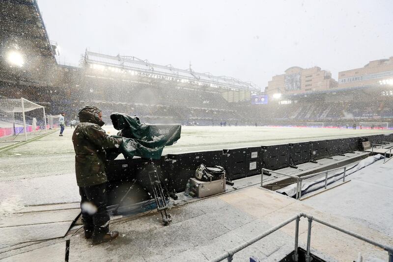 A television camera operator braves the snow ahead the FA Cup fourth-round tie between Chelsea and Luton Town at Stamford Bridge on Sunday, January 24. Getty