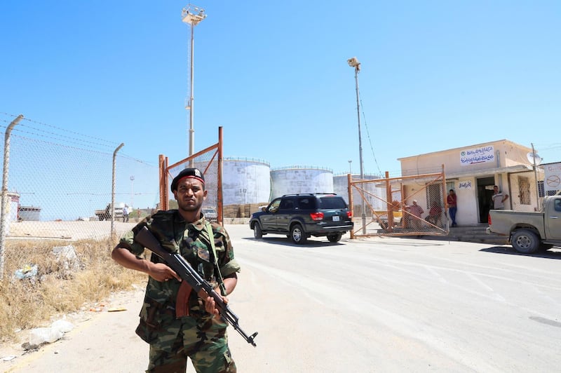 A member of the Petroleum Facilities Guard is seen at the entrance of Azzawiyah Oil Refinery in Zawiyah. Reuters