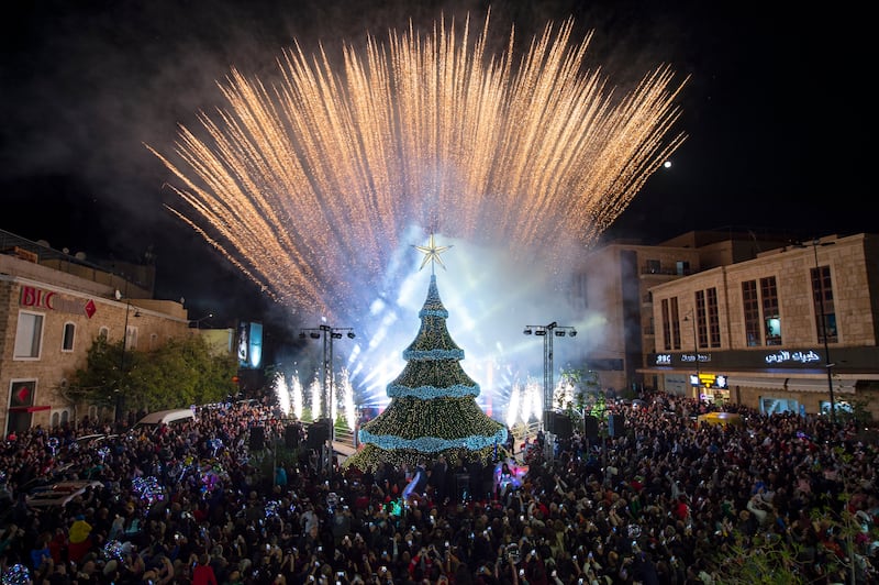 A light show behind the Christmas tree gave Byblos locals a reason to celebrate, despite an uncertain future during Lebanon's economic crisis. EPA