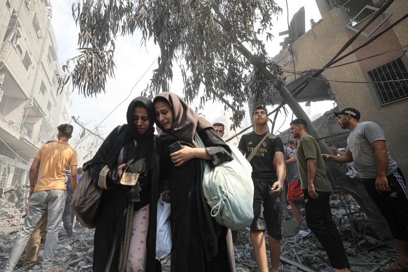 Palestinians evacuate the area after an Israeli air strike on Al Sousi Mosque in Gaza city. AFP