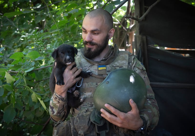 A Ukrainian and his puppy in the Donetsk region. AP