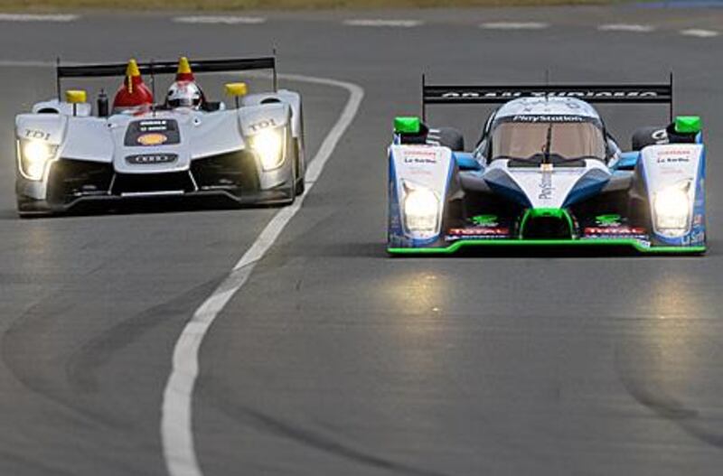 The Audi R15 TDi  driver Dindo Capello, right, overtakes the  Peugeot 908 Hdi-Fap driven by French Jean-Christophe Boullion during qualifying for the famous 24 hour race.