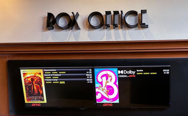 A cinema box office screen announcing the opening of Oppenheimer and Barbie in Los Angeles. AFP