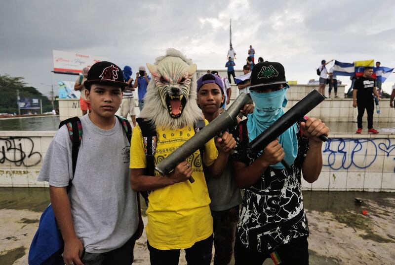 Boys pose with home-made mortars during a protest by anti-government demonstrators demanding Nicaraguan President Daniel Ortega and his wife, Vice President Rosario Murillo, to stand down, in Managua. Inti Ocon / AFP