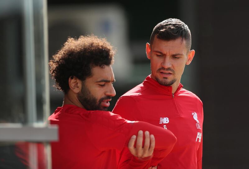 Liverpool's Mohamed Salah and Dejan Lovren walk out to the training pitch at Melwood. Reuters