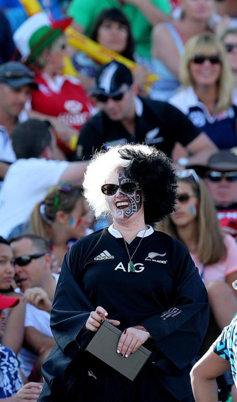 A New Zealand fan gets into the spirit with face paints and a wig at Dubai Rugby Sevens on Friday. Satish Kumar / The National 