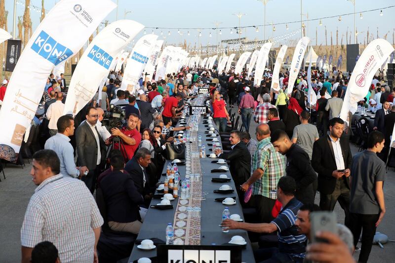 People receive a free Iftar at an official attempt for the longest Iftar table in the world, at the new administrative capital, 45km east of Cairo, Egypt.  EPA