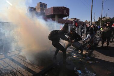 Iraqi protesters clash with riot police following an anti-government demonstration in Al Khilani Square in Baghdad. AFP