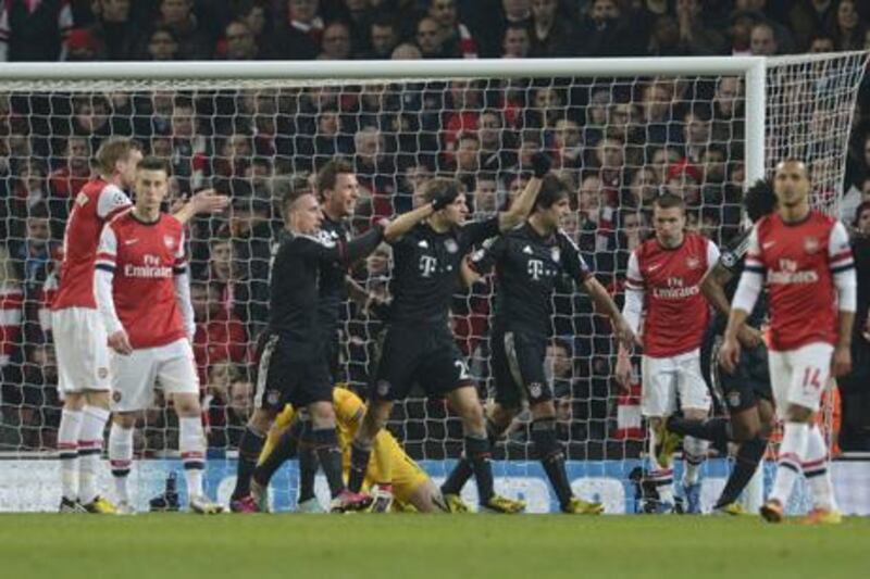 Bayern Munich players celebrate Thomas Muller's goal against Arsenal.