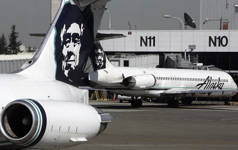 (FILES) In this file photo taken on September 25, 2006 Alaska Airlines planes are seen at Seattle-Tacoma International Airport. - An airline employee "conducted an unauthorized takeoff" of an airplane without passengers at the Seattle-Tacoma airport in the northwestern US state of Washington late Friday, August 10, 2018, airport officials said on Twitter. The aircraft "has crashed in south Puget Sound," Sea-Tac Airport said, adding that normal operations at the airport had resumed. Alaska Airlines on Twitter said the airplane was a turboprop Q400 airplane belonging to Horizon Air. (Photo by GABRIEL BOUYS / AFP)