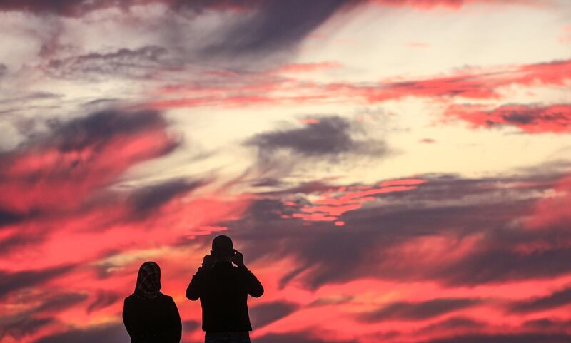 A Palestinian couple takes a selfie during sunset on a beach located on the Mediterranean Sea in western Gaza City, Gaza Strip. EPA