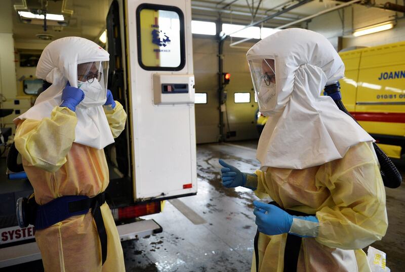 Medical staff members of M2 Ambulance company wear their protective suits as they prepare before the transport of a patient infected with the coronavirus disease (COVID-19) in Ottignies, Belgium, October 23, 2020. REUTERS/Johanna Geron