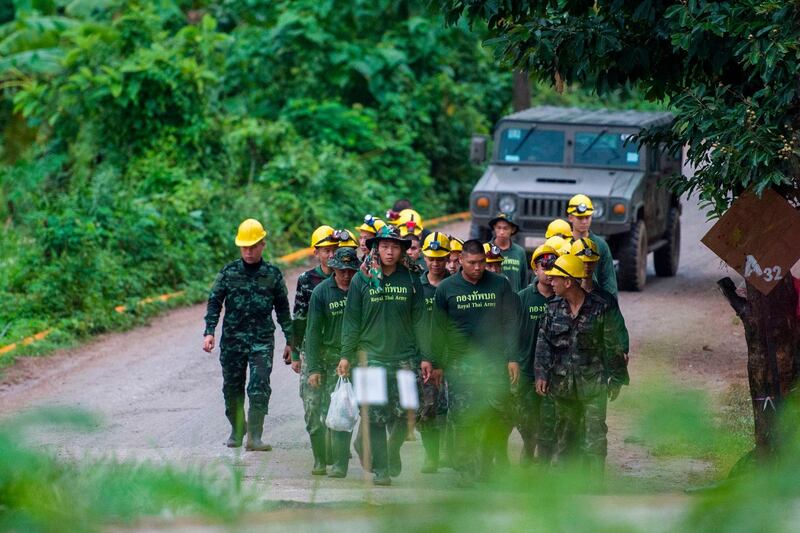 Thai soldiers walk out from the Tham Luang cave area. The rescue operation to save the remaining nine members of a football team enters its second day. AFP