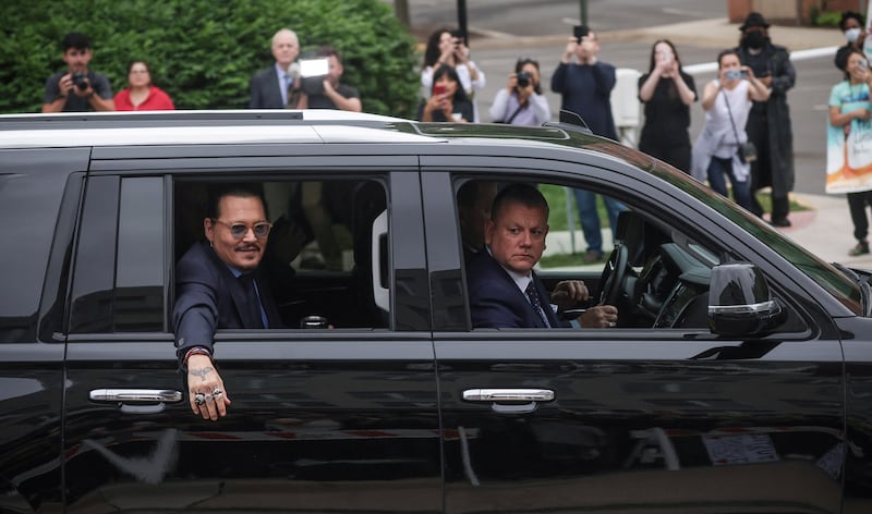 Depp waves to fans. Reuters