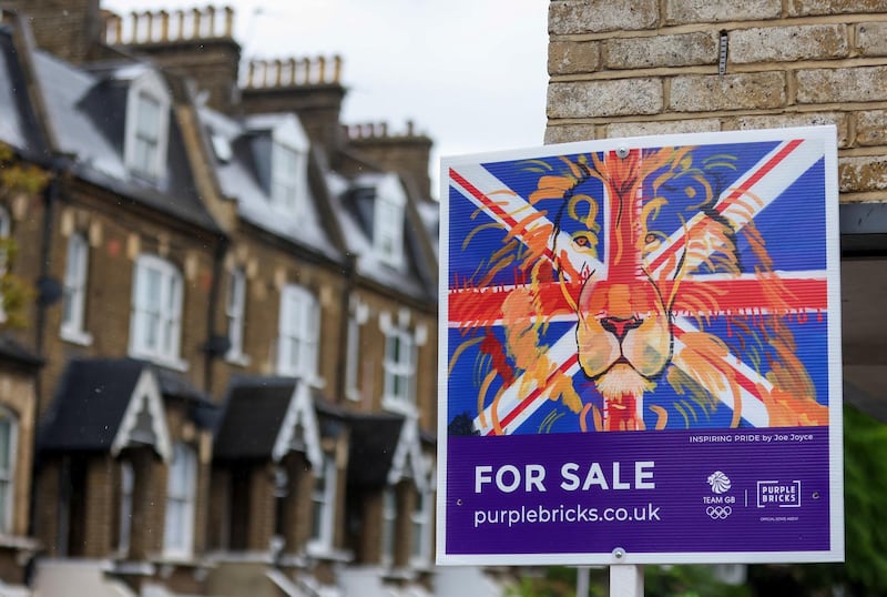 A Purple Bricks estate agents 'For Sale' board outside residential properties in London, U.K., on Friday, May 21, 2021. After a year of shunning the capital amid lockdowns and coronavirus, many renters are now looking to return to urban life as restrictions ease, according to data from estate agent Hamptons International. Photographer: Chris Ratcliffe/Bloomberg