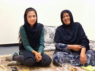 Momina Sangari sits with her daughter after an iftar. Hikmat Noori for The National 