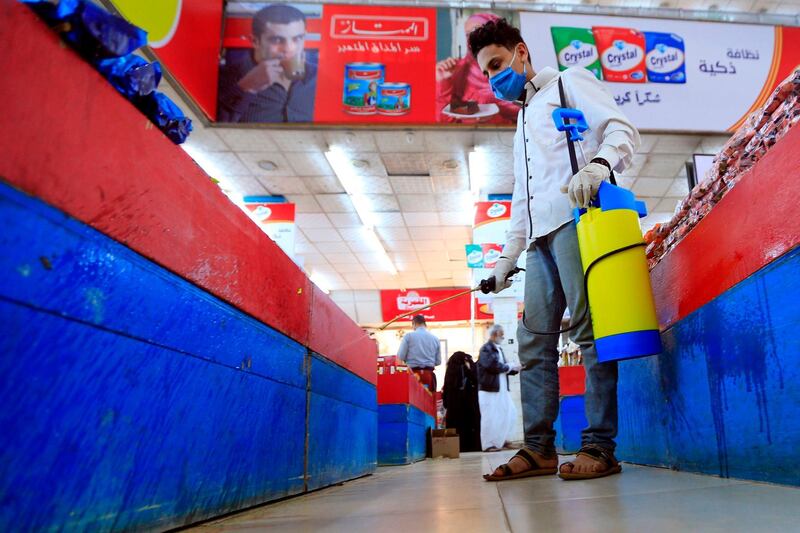 An employee disinfects a supermarket in the Yemeni capital Sanaa. AFP