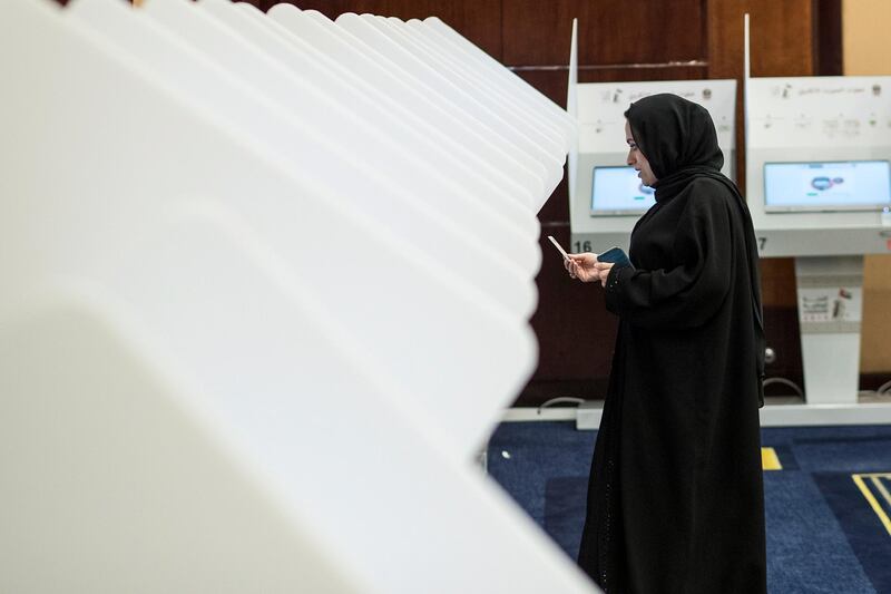 An Emirati woman votes by electronic voting system at a polling centre in Dubai. EPA