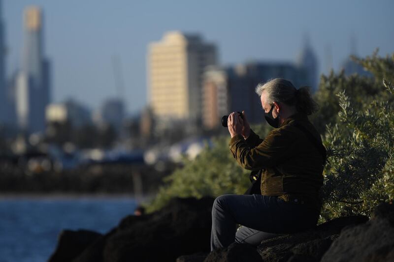 A woman takes a photo in Melbourne, Australia. EPA
