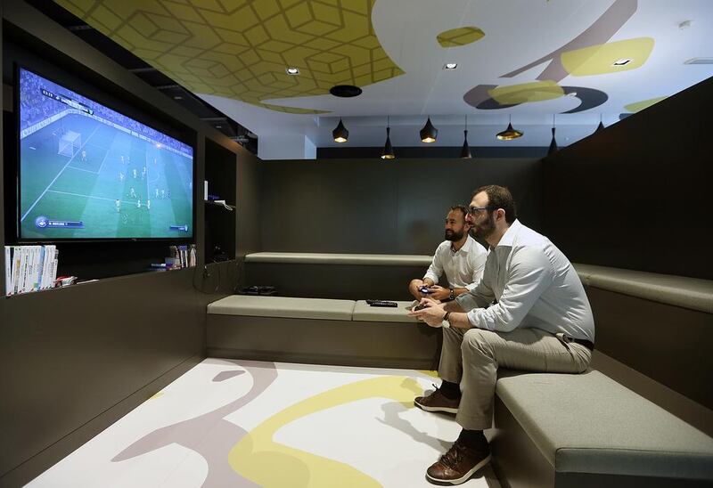 Employees play games at the Google office in Dubai. Satish Kumar / The National