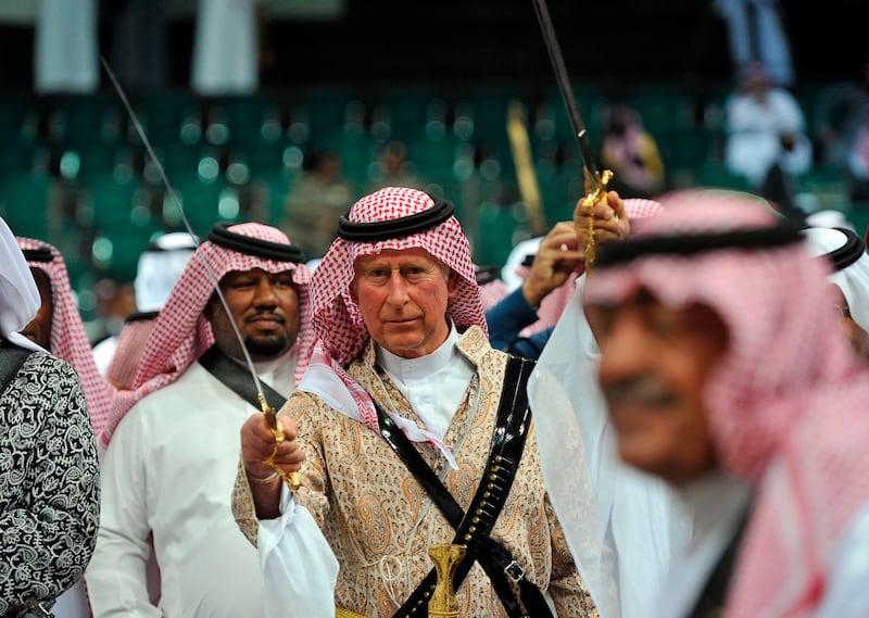 Prince Charles wears a traditional Saudi uniform to perform a sword dance, known as ardah, in Riyadh in 2014. Reuters