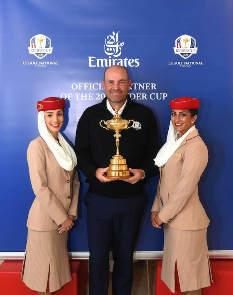 Emirates Cabin Crew and Thomas Bjørn, the European Ryder Cup Team Captain pose with The Ryder Cup. Courtesy Emirates