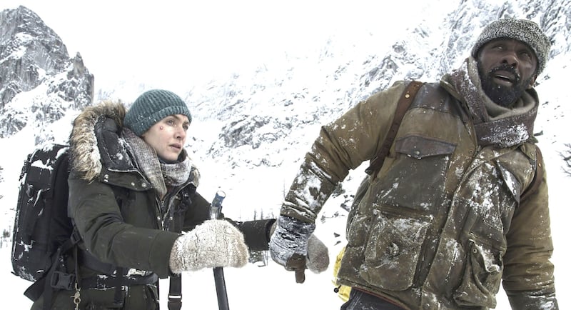 Kate Winslet, left, and Idris Elba play stranded survivors of a plane crash
in "The Mountain Between Us." (Kimberley French/Twentieth Century Fox)